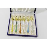 A cased set of six Danish silver gilt and coloured enamel harlequin spoons, in fitted box