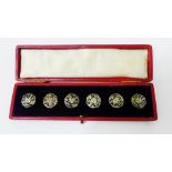 A set of six white metal Art Nouveau flower buttons, in red leather fitted case, (6)