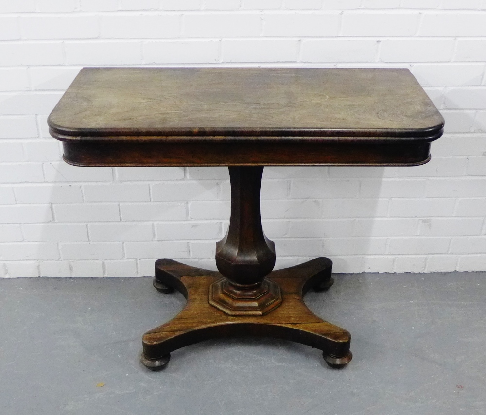 A 19th century rosewood fold over tea table, on a facet column and quadripite base, 76 x 96cm,