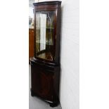 A modern mahogany corner cabinet, with shelved interior over a cupboard base, 182 x 66cm