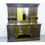 A mirror back carved mahogany sideboard, with two central doors above a central cupboard flanked