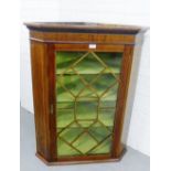 A mahogany hanging corner cupboard with astragal glazed door and a shelved interior, 106 x 82cm