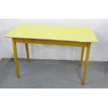 A retro yellow Formica topped pine kitchen table, 77 x 122cm