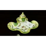 A Dresden porcelain inkwell with green scale reserves and rococo style gilding and hand painted