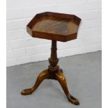 A mahogany wine table, the square top with canted corners, raised on baluster column and tripod