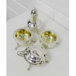 An Edwardian silver condiment set comprising pepper pots, mustard and two circular salts, Chester