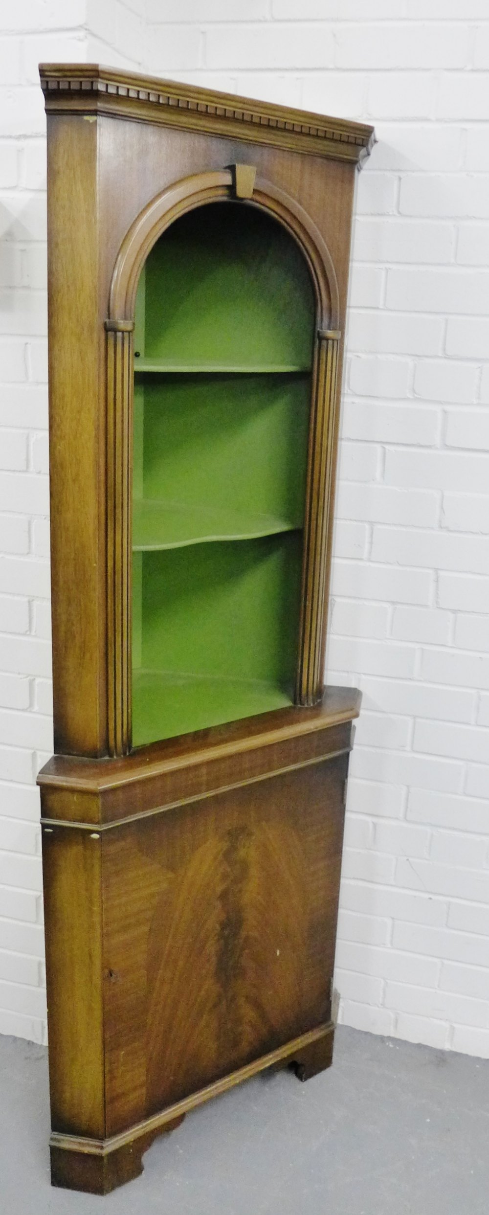 A floor standing mahogany corner cabinet, fitted with two open shelves, over a cupboard base, 180