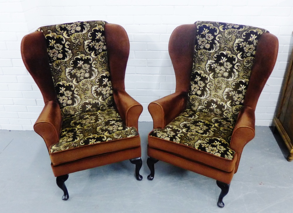 A pair of Parker Knoll wing armchairs, upholstered in brown fabric, 104 x 107cm