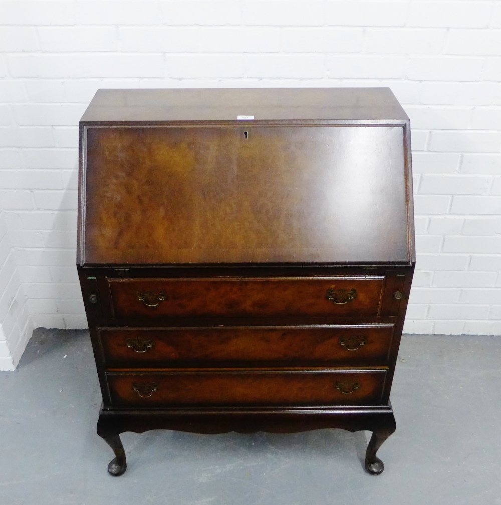 A burr wood bureau, the fallfront with a fitted interior, above pull out slides and three long