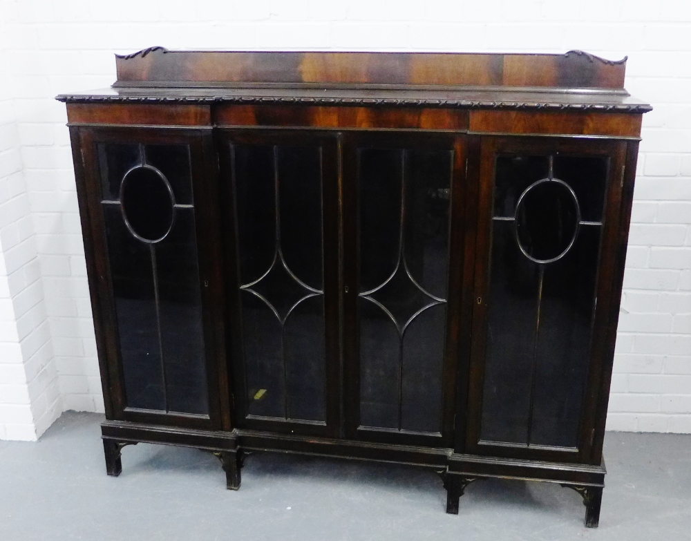 A mahogany ledgeback bookcase, with three astragal glazed doors, raised on straight block