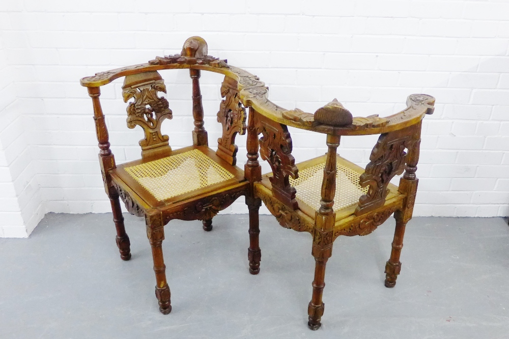 A European hardwood love seat, with carved splat backs and canework seats, 90 x 128cm