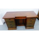 A mahogany desk, with central cupboard flanked by four short drawers to each pedestal, 78 x 140cm