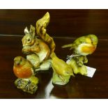 A Beswick figure of a Robin, a Royal Worcester figure of a Wren, another unmarked figure of a
