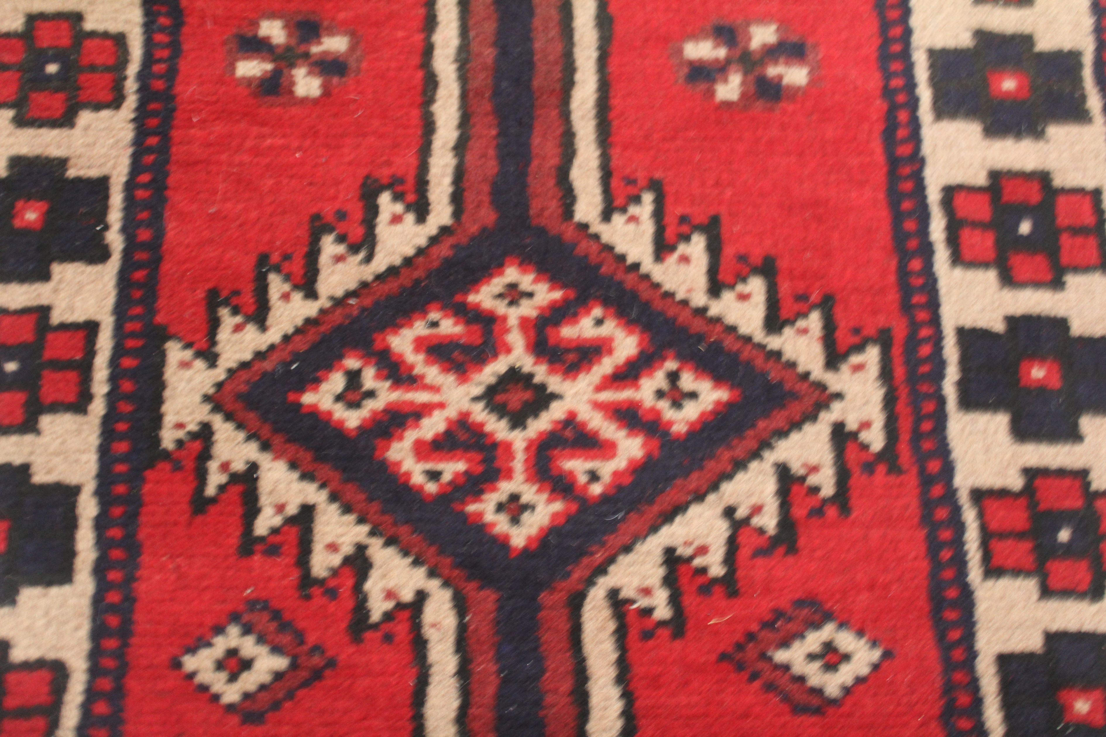 An Afghani wool runner, of thick pile, central banding of joined medallions on claret ground, the - Image 2 of 4