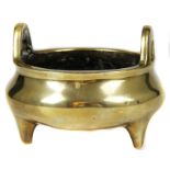 A Chinese bronze tripod censer, circular with high loop handles, and on tripod feet, Xuande six