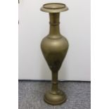 A large brass mosque vase, ovoid body with wide everted flared neck on socle base, 92cm high