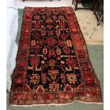 A claret ground carpet of traditional asymmetric design, probably Turkish, c1950, 288 x 140cm