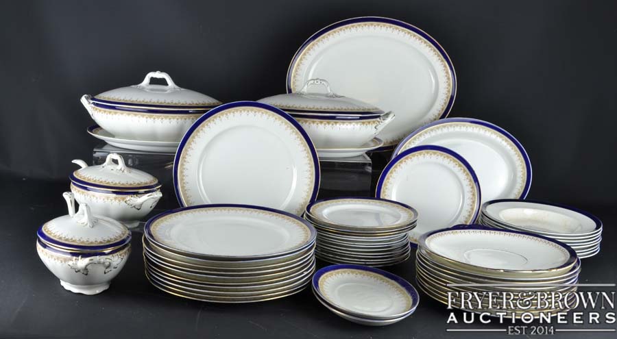 A Victorian English earthenware dinner service, white with blue and gold banding to edge, comprising