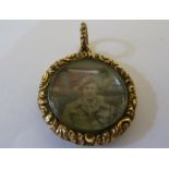 A mid 19thC yellow gold locket pendant of circular shape, the border finely carved and engraved with
