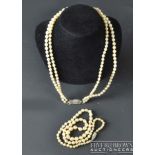 A two row graduated cultured pearl necklace to a paste clasp comprising 74 and 72 graduated cultured