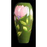 A large Moorcroft Potter 'Magnolia pattern' vase, bullet form ,dark green ground, facsimile Walter