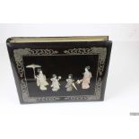 A Japanese lacquer cover photograph album, inset with mother of pearl and bone, Geisha with