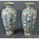 A pair of Chinese cloisonné vases, of ribbed baluster form, profusely decorated with polychrome