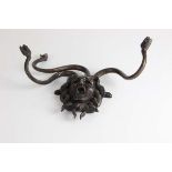 A French cast bronze Medusa head hat stand, formed with a mask head with open mouth encircled by