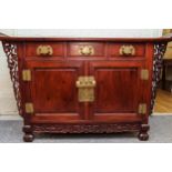 A Chinese hardwood Altar Cabinet with three short drawers over two doors. The rectangular top with