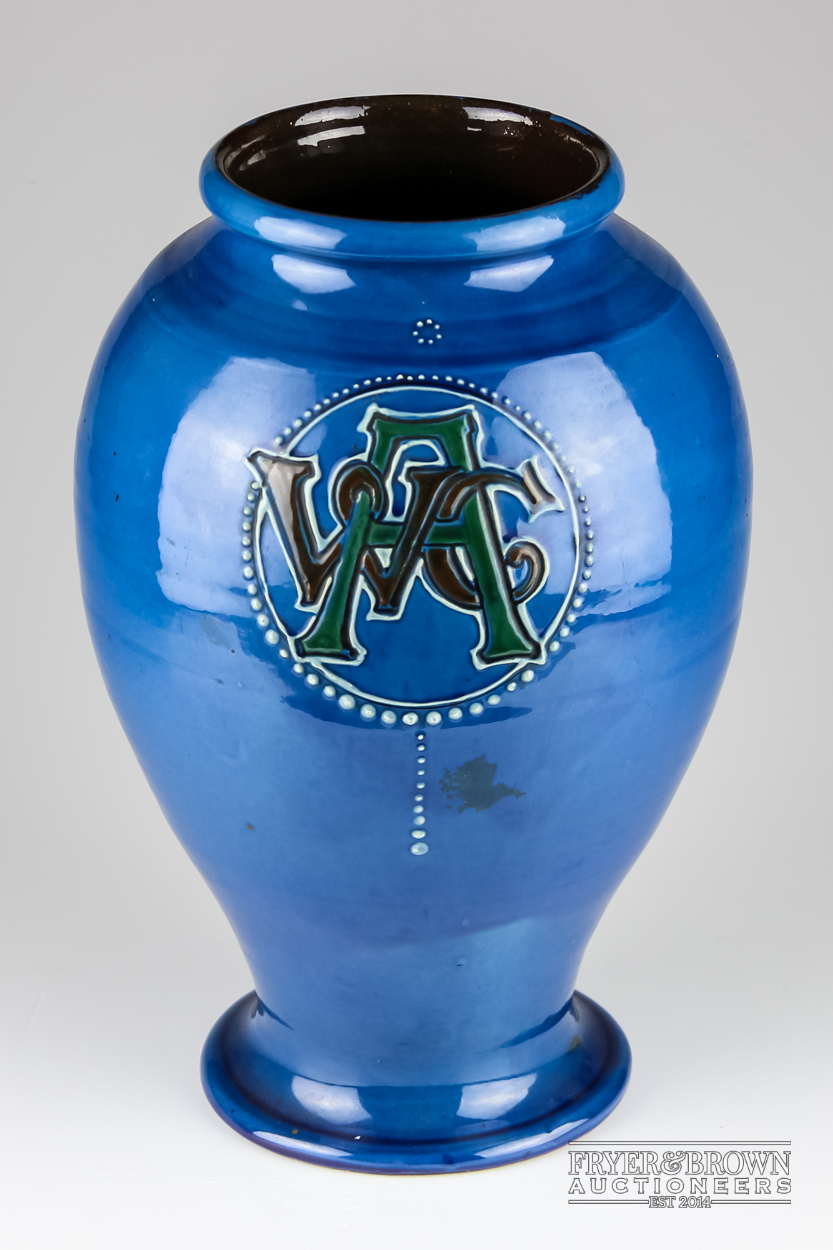 A C.H Brannam pottery vase, squat baluster form, incised with monogramme AWC within a beaded reserve