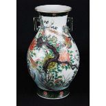 A Chinese famille verte vase, of two handled baluster form, decorated with a bird amid magnolia