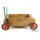 A vintage child's toy push cart