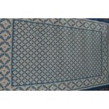 A modern cream and blue wool rug, patterned with laurel trellis and oak leaf, 122cm wide