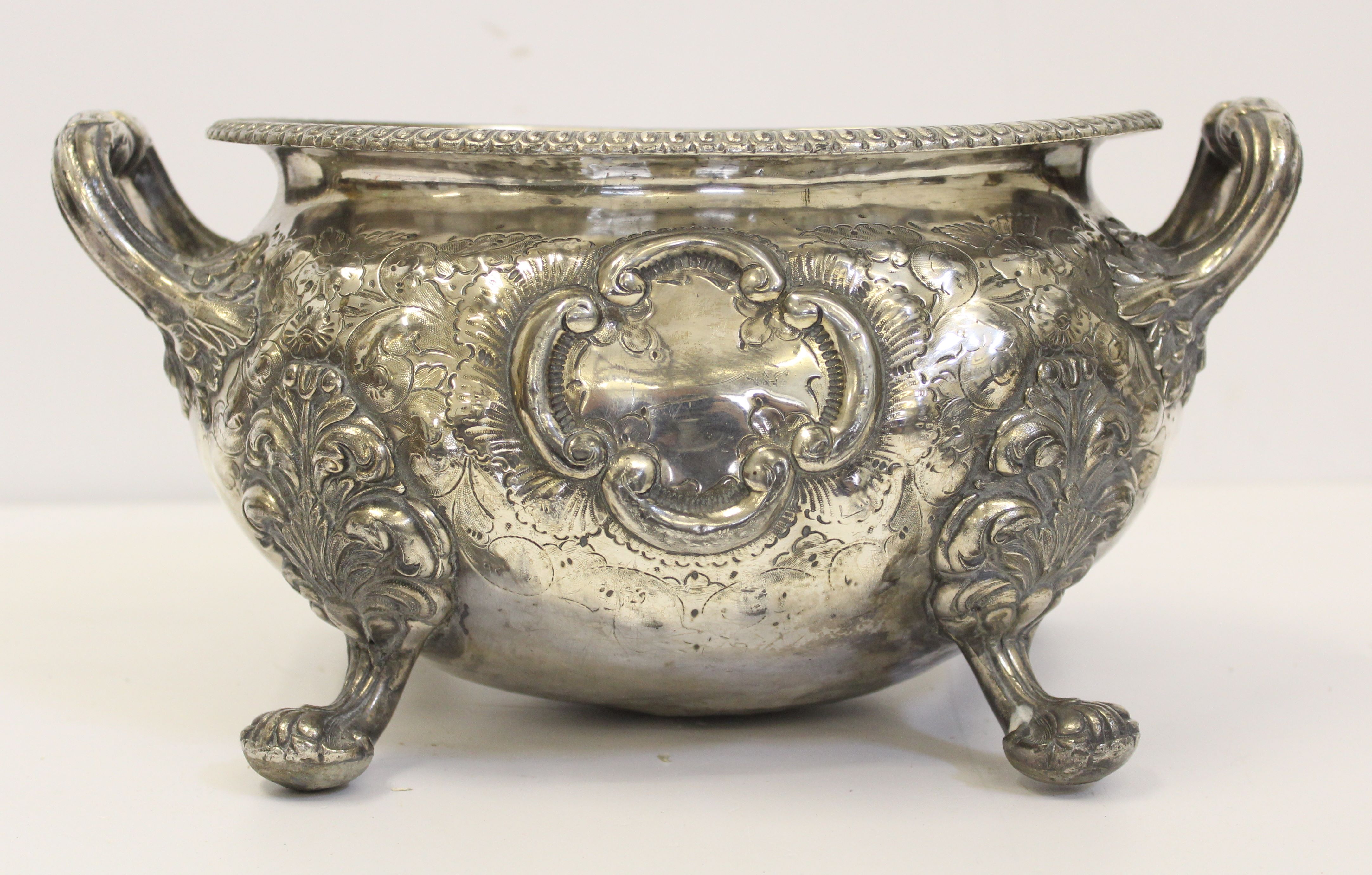 A silver plated oval footed jardinière or tureen, on four paw feet with high loop handles