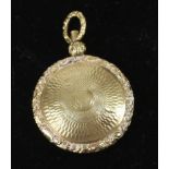 A small 15ct yellow gold locket, c1840, of circular form with carved floral borders