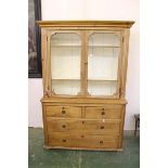 A vintage glazed pine dresser, glazed doors, two fixed plate shelves, glazed top sitting on lower