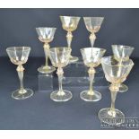 Eight Salviati wine glasses, the bowls of octagonal section, adventurine inclusions to body and