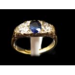 A Victorian sapphire and diamond three stone ring, c1880, the carved scrolled 18ct yellow gold