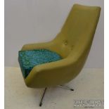 A 1960's olive green leatherette swivel lounge chair, on chromed X form base, 97cm high