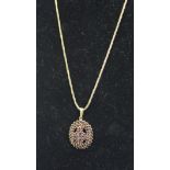 A yellow metal garnet cluster pendant oval; together with a 9ct rope twist chain, 10grs total weight