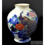 A Japanese Fukagawa Koransha porcelain ovoid vase, painted with a peacock amid peony blossom and