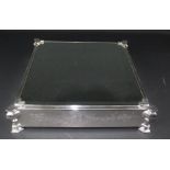 An unusual mirror glass topped silver plated wedding cake stand, the bevelled glass inset on an