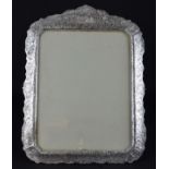 A large Dutch style silver plated rectangular photograph frame, of shaped edge, the copper body