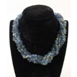 An unusual aquamarine, blue topaz and gold roundell necklace, the four rows of graduated natural