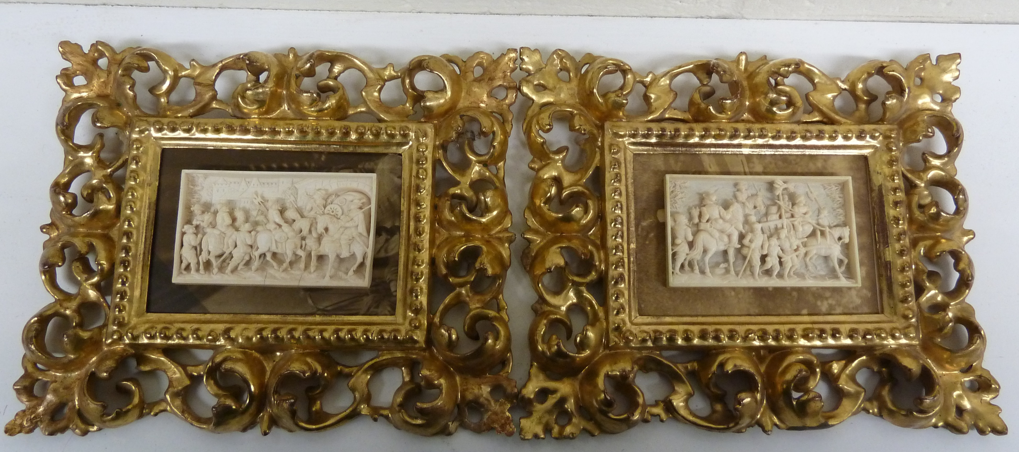 A very fine pair of antique Dieppe carved ivory plaquettes c1860 in contemporary carved gilt wood