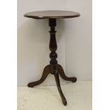 A early 19thC fruitwood and mahogany wine table, circular top with bevelled edge on a tripod base on