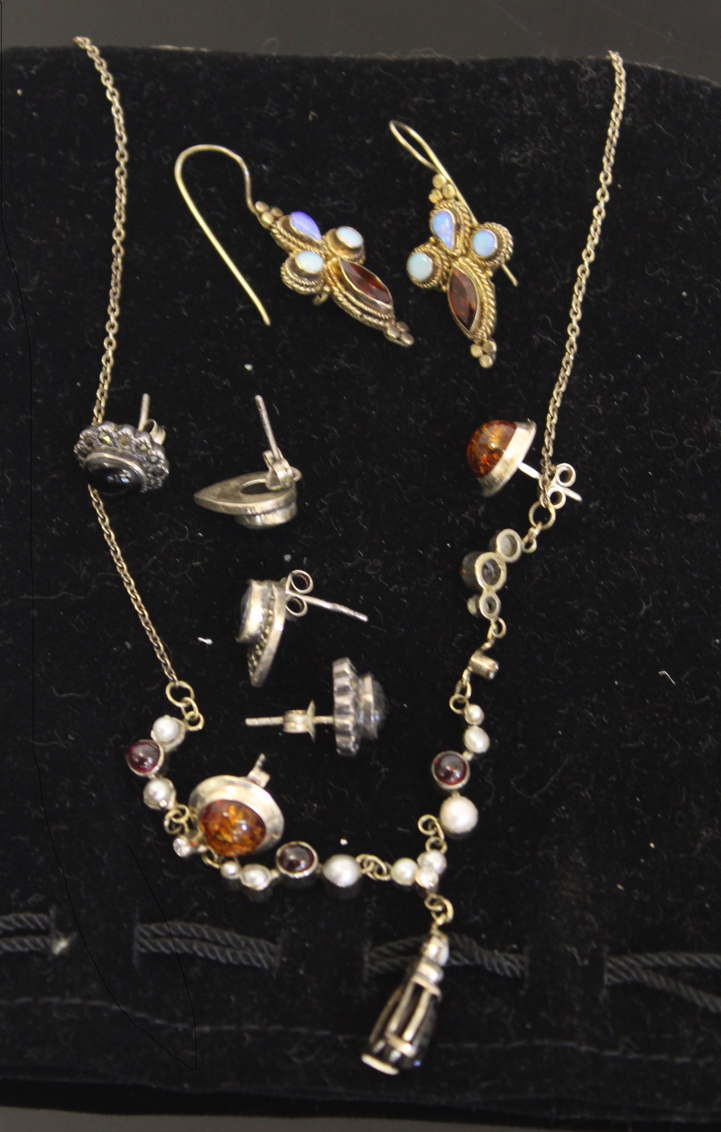 A silver garnet, pearl and diamond set necklace; a pair of Venetian style earrings stamped 925;