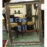 A gilded gesso framed wall mirror, decorated with 'c' scroll reserves and floral sprays, 98 x 76cm