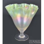 A Walsh Walsh iridescent nacreous threaded glass vase, with pale green threading to the wavy rim