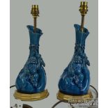 A pair of Japanese pottery figural vase lamp bases, the gourd form body with Daikokuten holding a